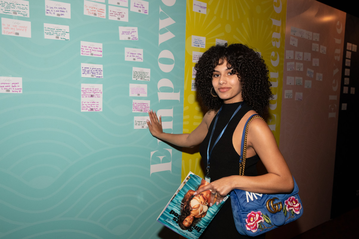 A TSN member stands next to her pledge at the event.